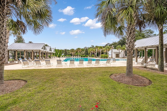 view of swimming pool featuring a lawn and a patio