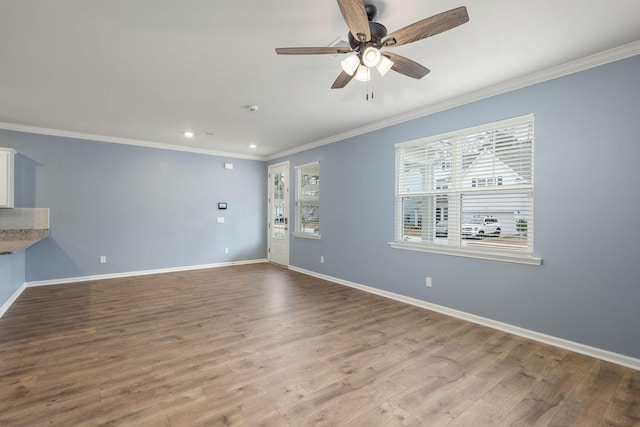 spare room featuring light wood-type flooring, ceiling fan, and crown molding