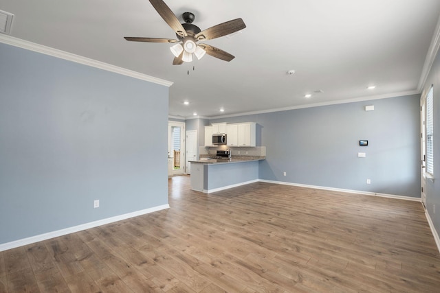 unfurnished living room featuring crown molding, ceiling fan, and light wood-type flooring