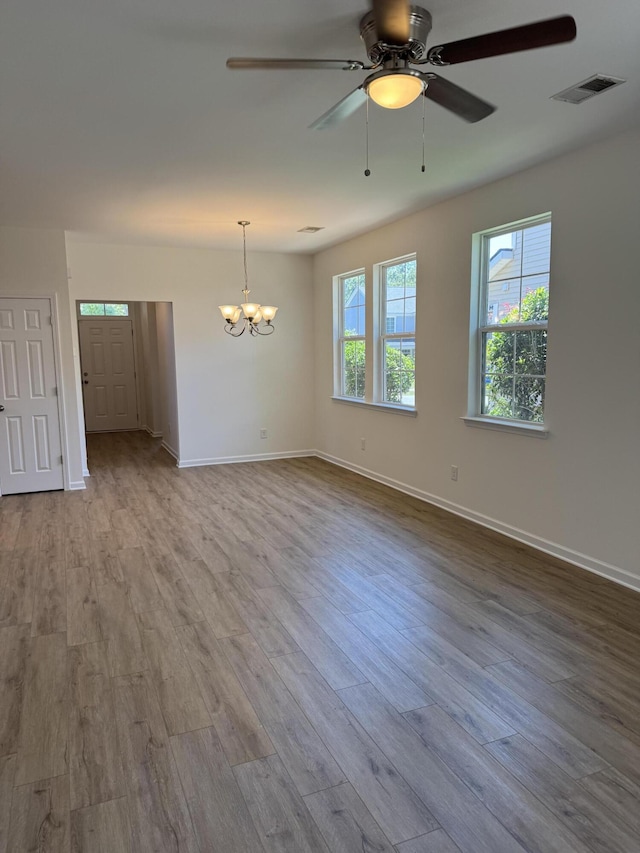 1208 N University Dr Unit A, Ladson, SC 29456 - empty room with ceiling fan with notable chandelier, baseboards, wood finished floors, and visible vents