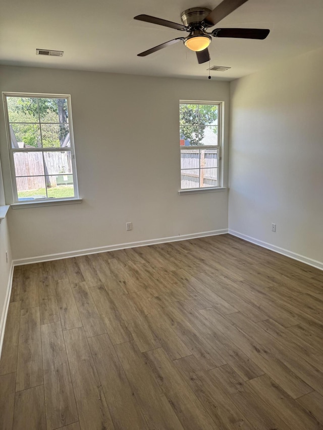 1208 N University Dr Unit A, Ladson, SC 29456 - spare room featuring dark wood-type flooring, visible vents, a ceiling fan, and baseboards