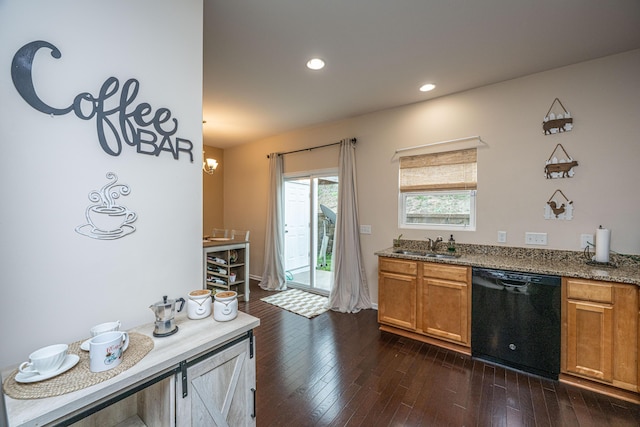 kitchen with dishwasher, dark wood-type flooring, brown cabinets, and a sink