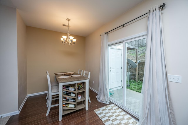 dining area with a chandelier, visible vents, baseboards, and dark wood-style flooring