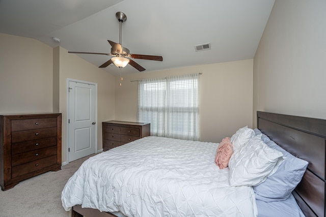 bedroom featuring visible vents, light colored carpet, ceiling fan, and vaulted ceiling