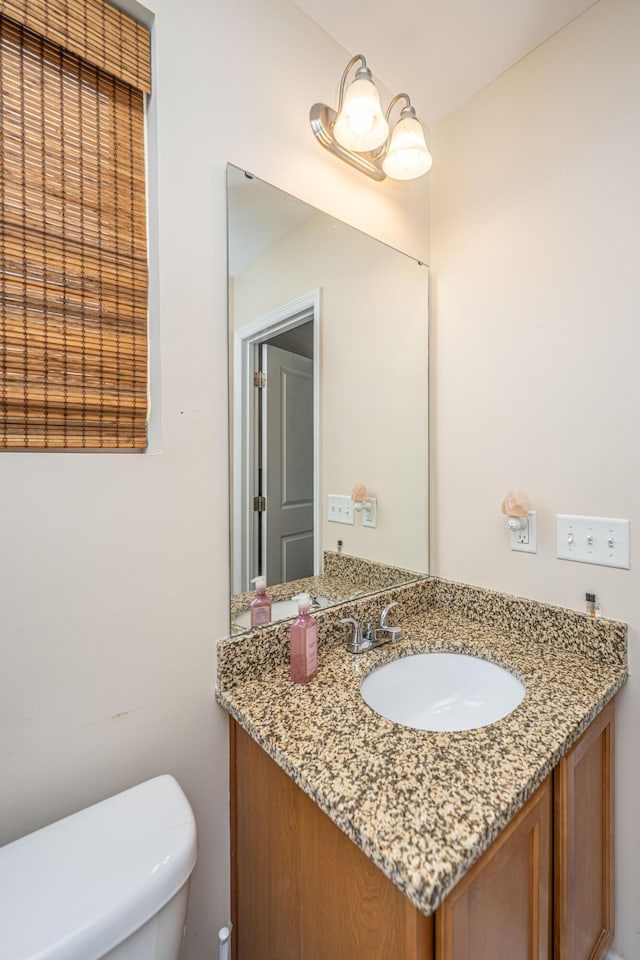 bathroom with toilet and vanity