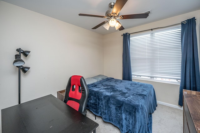 bedroom featuring baseboards, multiple windows, carpet floors, and a ceiling fan