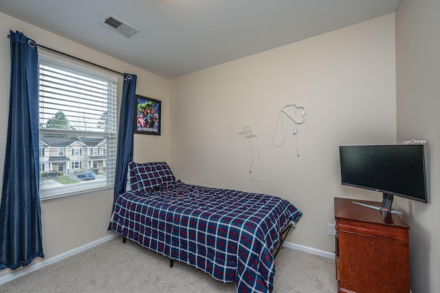 carpeted bedroom featuring baseboards and visible vents