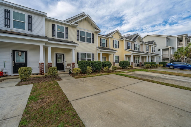 multi unit property featuring board and batten siding, covered porch, and a residential view