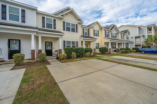 multi unit property with a residential view, covered porch, and board and batten siding