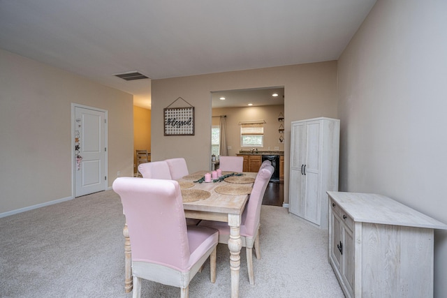 dining room with visible vents, light carpet, and baseboards