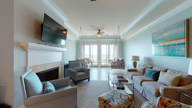 living room with french doors, a fireplace, ceiling fan, and light tile floors