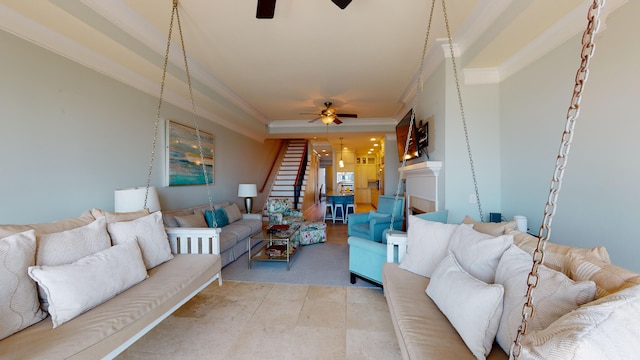 tiled living room featuring ceiling fan, crown molding, and a tray ceiling