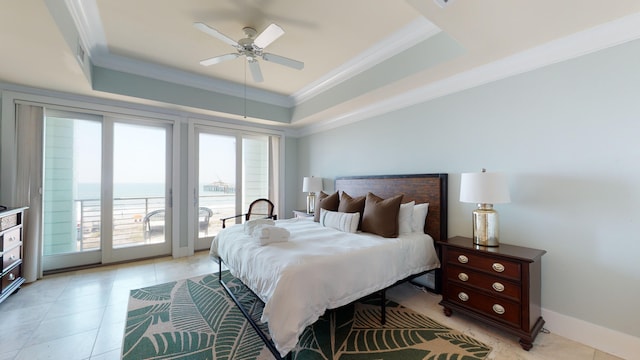 tiled bedroom with ceiling fan, crown molding, a water view, and a tray ceiling