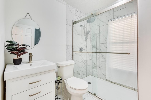 bathroom featuring vanity, toilet, and a shower with door