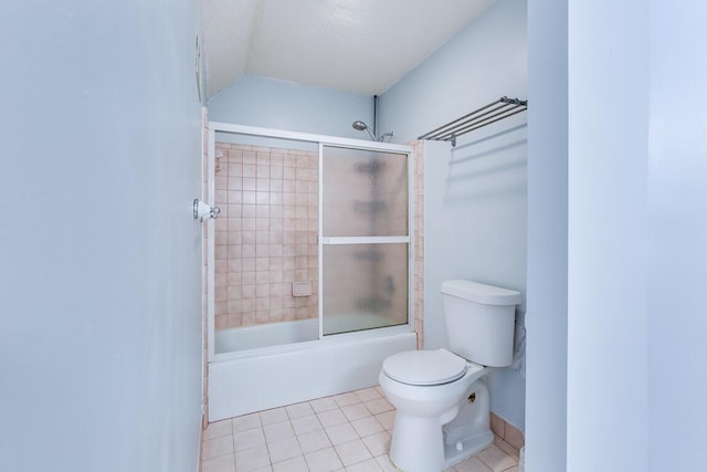 bathroom featuring tile patterned flooring, a textured ceiling, lofted ceiling, bath / shower combo with glass door, and toilet