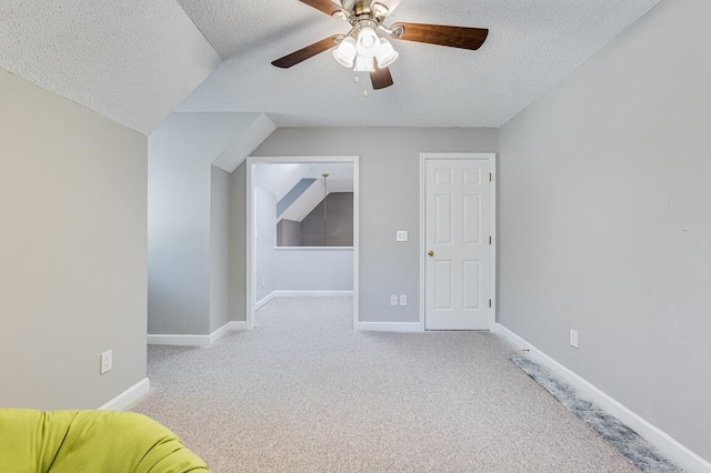 bonus room featuring ceiling fan, a textured ceiling, and vaulted ceiling