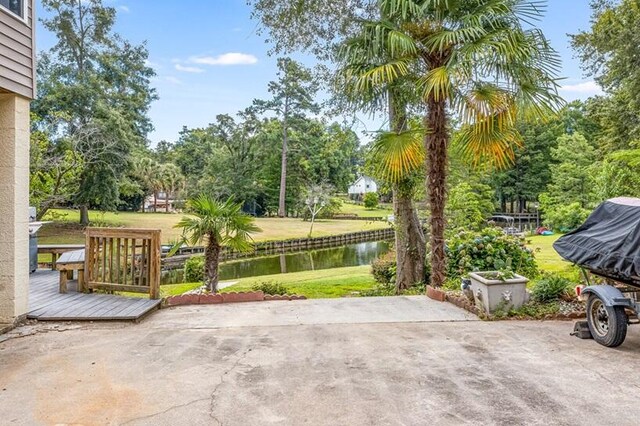 view of patio / terrace with a deck with water view