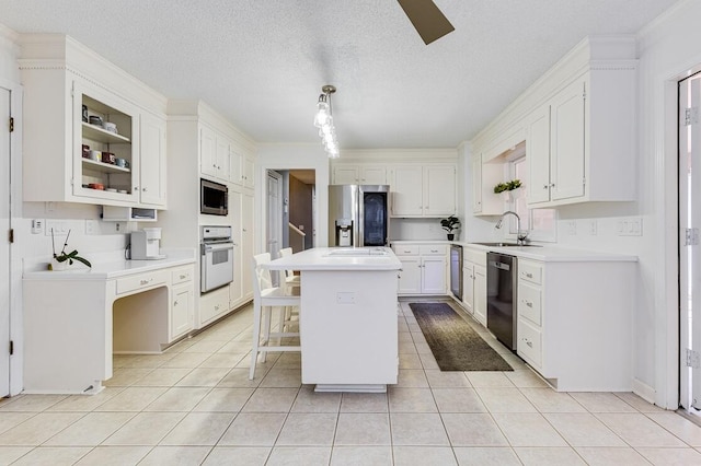 kitchen with a kitchen island, white cabinetry, appliances with stainless steel finishes, pendant lighting, and sink