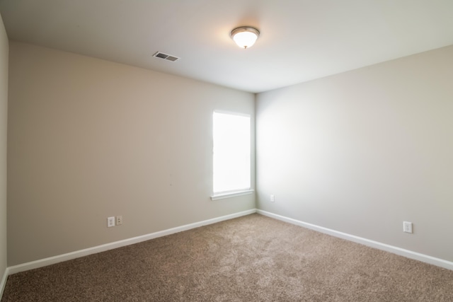 empty room with carpet and baseboards