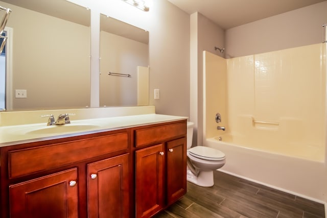 full bathroom featuring wood finished floors, bathing tub / shower combination, toilet, and vanity