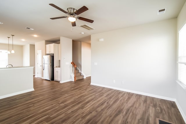 unfurnished living room with baseboards, dark wood-type flooring, ceiling fan, stairway, and recessed lighting