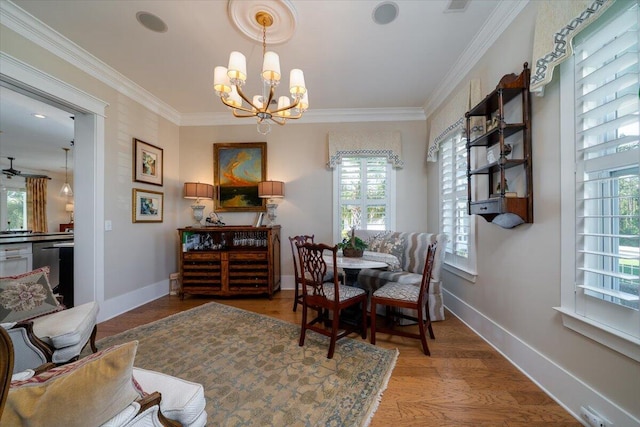 dining room featuring a chandelier, wood finished floors, a wealth of natural light, and baseboards