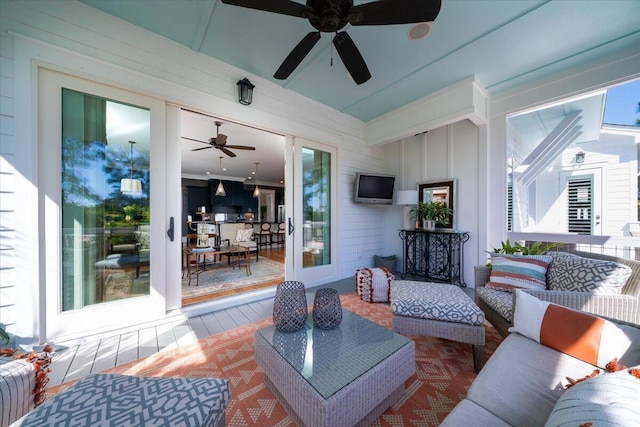 living room with a wealth of natural light and ceiling fan