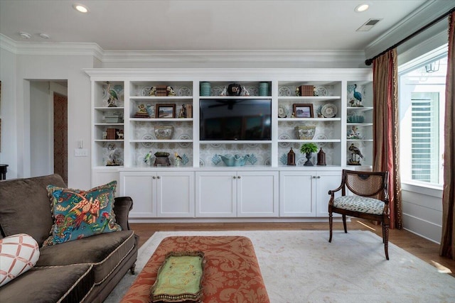 living room with light wood-type flooring, visible vents, recessed lighting, and crown molding