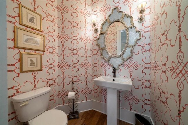 bathroom featuring wood finished floors and toilet