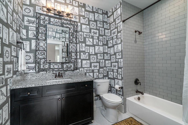 bathroom with tile patterned floors, toilet, wallpapered walls, vanity, and shower / tub combination