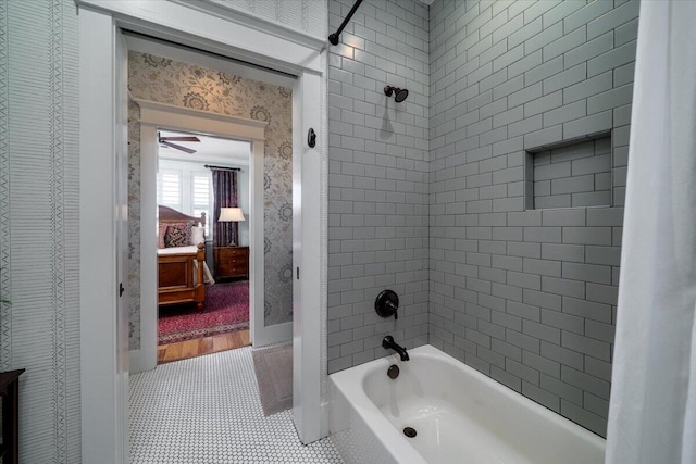 full bathroom featuring washtub / shower combination, wallpapered walls, tile patterned floors, a ceiling fan, and baseboards