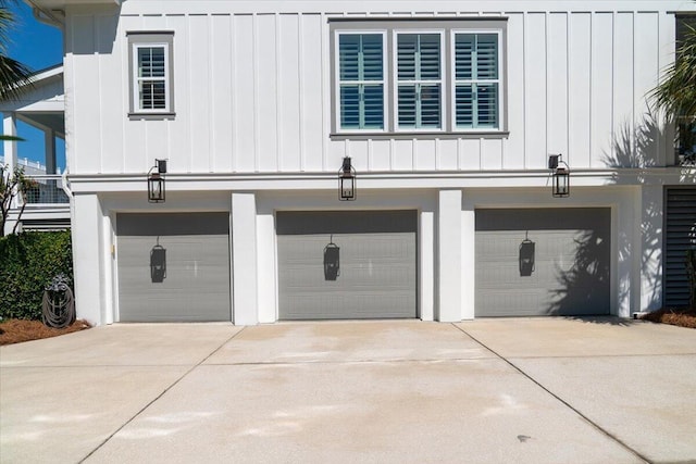 exterior space featuring board and batten siding, concrete driveway, and a garage
