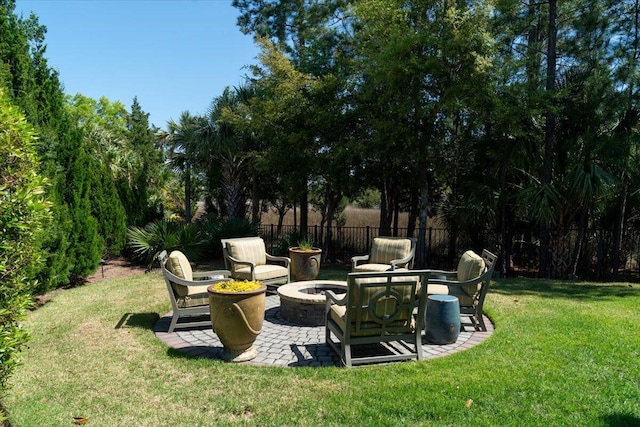 view of yard featuring fence, a patio, and an outdoor fire pit