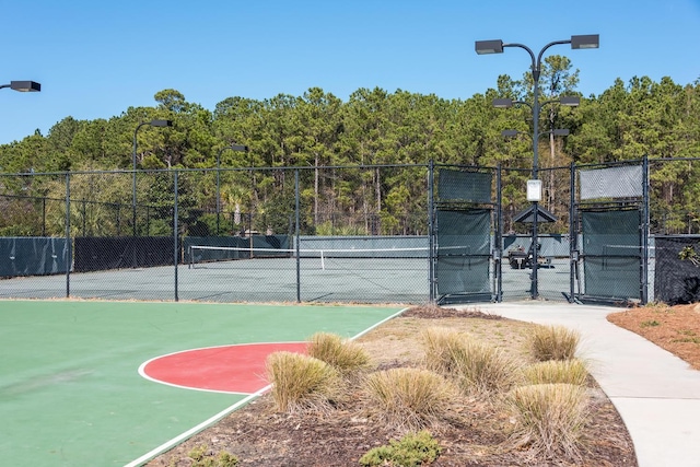 view of sport court featuring a gate, fence, and community basketball court