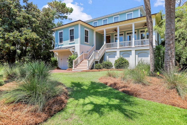 raised beach house featuring ceiling fan, a porch, and a front yard