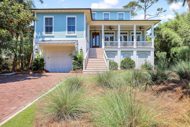 coastal home with ceiling fan, french doors, and a garage