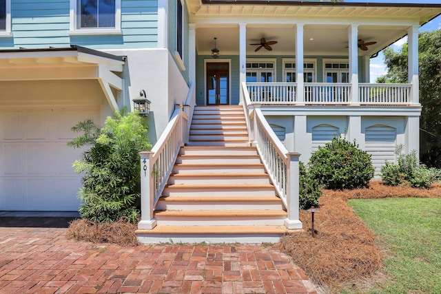 doorway to property featuring ceiling fan, french doors, covered porch, and a garage