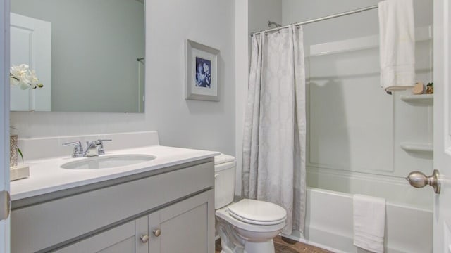bathroom with toilet, vanity, and shower / tub combo