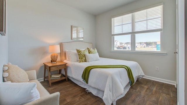bedroom featuring wood finished floors and baseboards