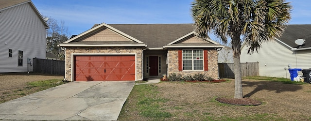 view of front facade featuring an attached garage, stone siding, fence, and concrete driveway