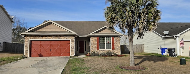 7646 Kinston St, North Charleston, SC 29418 - view of front of property featuring concrete driveway, an attached garage, fence, and stone siding