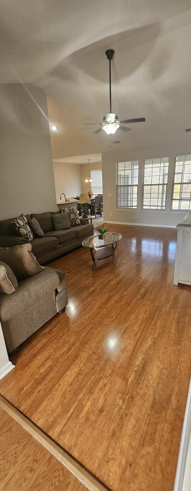 unfurnished living room featuring wood finished floors and a ceiling fan