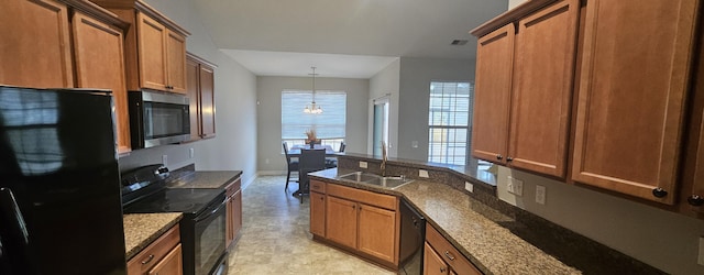 kitchen featuring dark stone countertops, brown cabinets, a sink, and black appliances