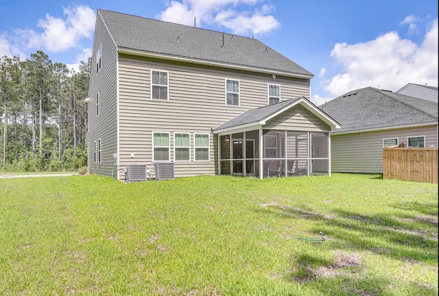 back of property with cooling unit, a yard, and a sunroom