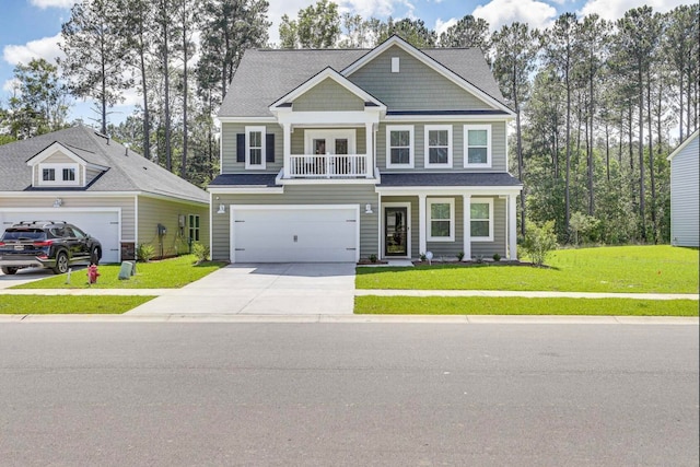 view of front of property featuring a garage, a front yard, and covered porch