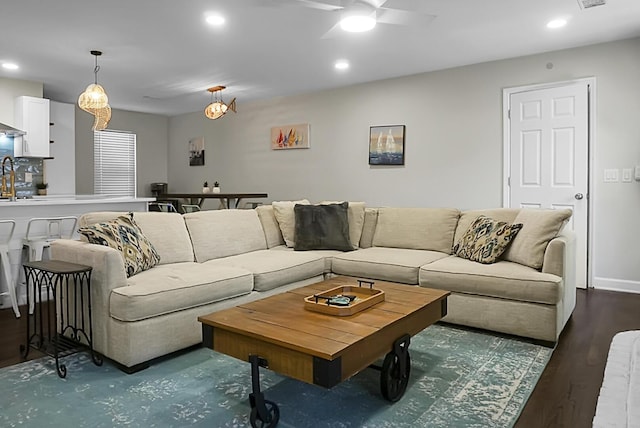 living room featuring ceiling fan, baseboards, wood finished floors, and recessed lighting