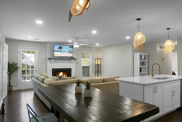 dining space featuring dark wood-type flooring, plenty of natural light, a fireplace, and recessed lighting