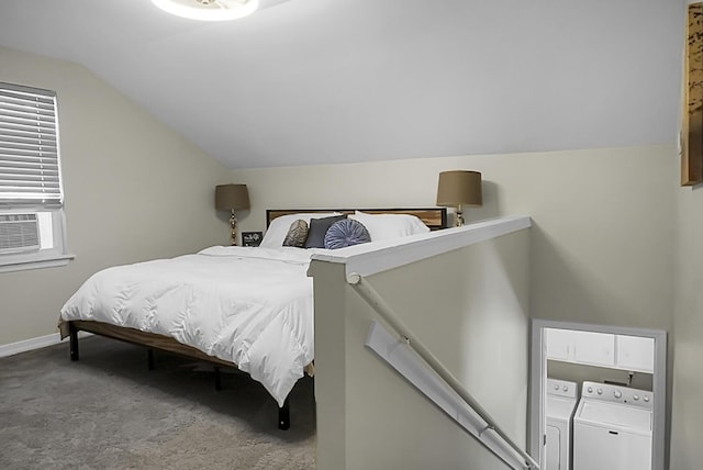 carpeted bedroom with baseboards, vaulted ceiling, and washer and dryer