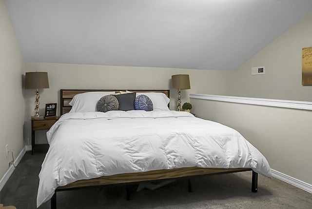 bedroom with vaulted ceiling and baseboards