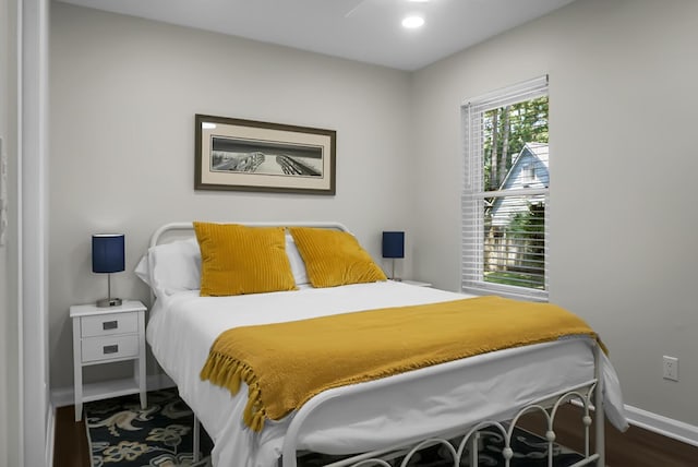 bedroom featuring baseboards and wood finished floors